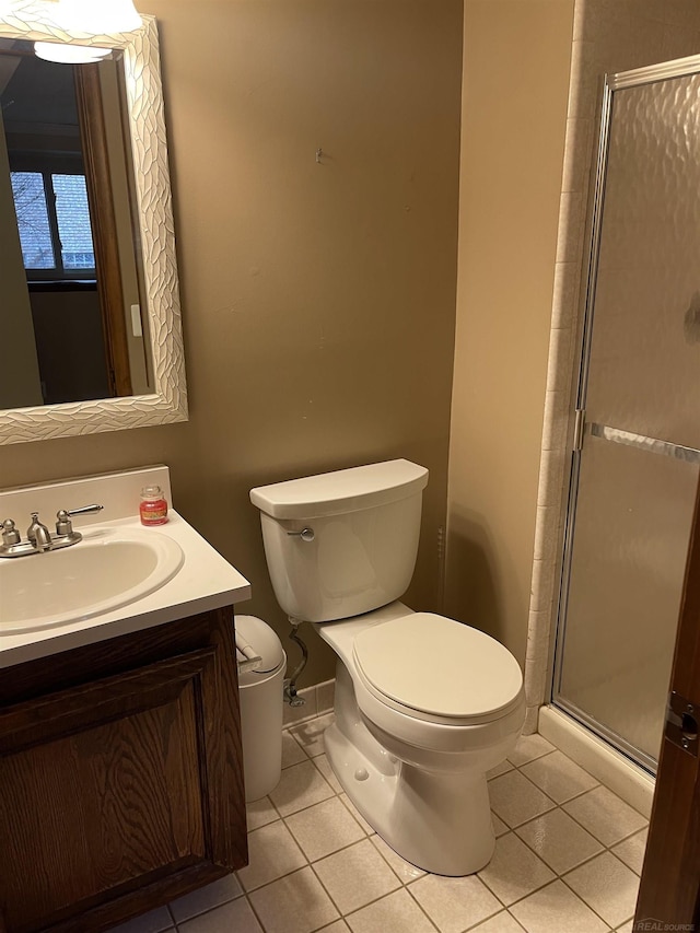 full bath with a stall shower, vanity, toilet, and tile patterned floors