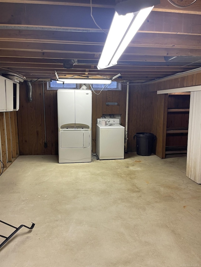 unfinished basement with washer and dryer and wood walls