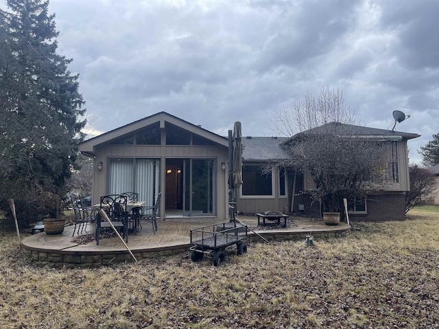 rear view of house featuring a fire pit and a patio area