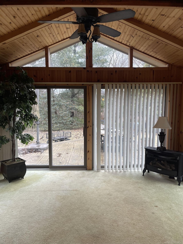 interior space featuring carpet floors, vaulted ceiling with beams, ceiling fan, and wooden ceiling