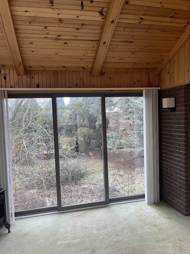 interior space featuring lofted ceiling with beams and wood ceiling