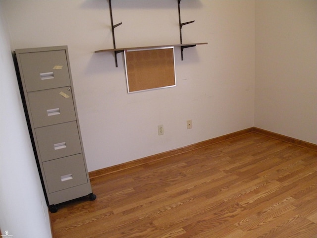 unfurnished room with light wood-style floors and baseboards