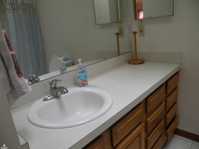 bathroom featuring tile patterned flooring and vanity