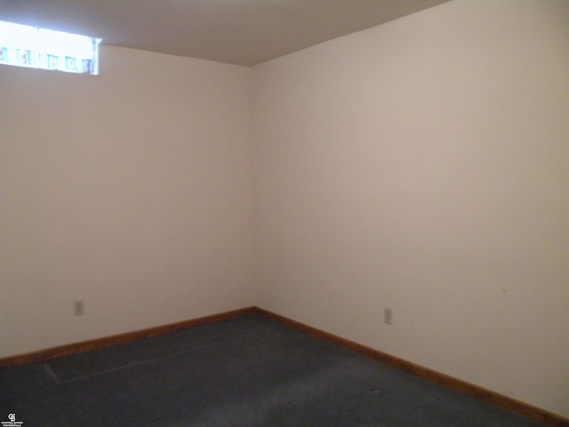 carpeted empty room with baseboards