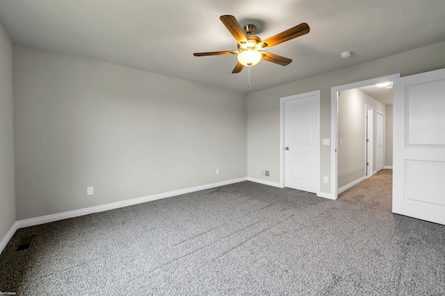 unfurnished bedroom featuring ceiling fan, carpet floors, visible vents, and baseboards