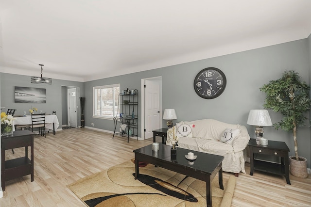 living room featuring light wood-type flooring and baseboards