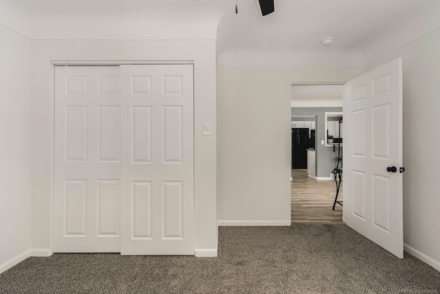 unfurnished bedroom featuring a closet, carpet flooring, and baseboards