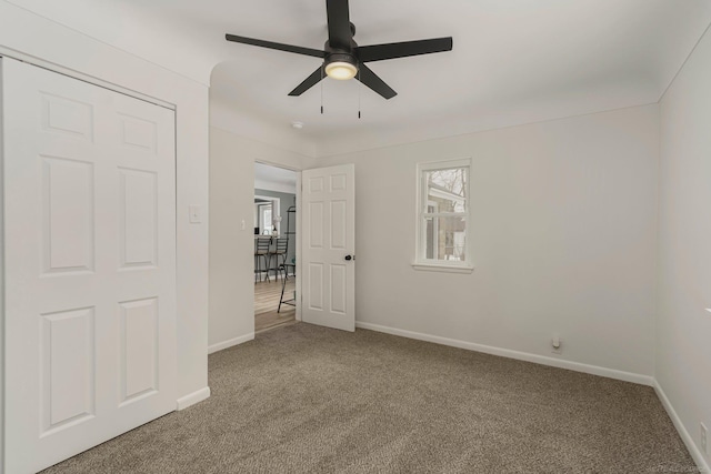 unfurnished room with carpet floors, ceiling fan, and baseboards