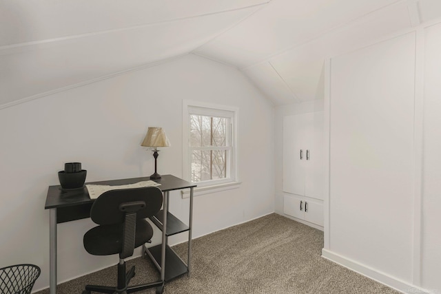 carpeted office with vaulted ceiling