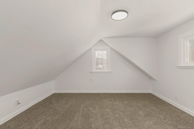 bonus room with carpet, baseboards, and vaulted ceiling