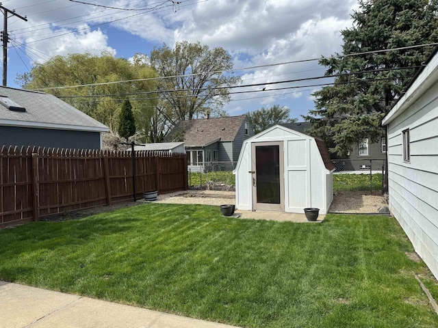 view of yard featuring a fenced backyard, an outbuilding, and a storage shed