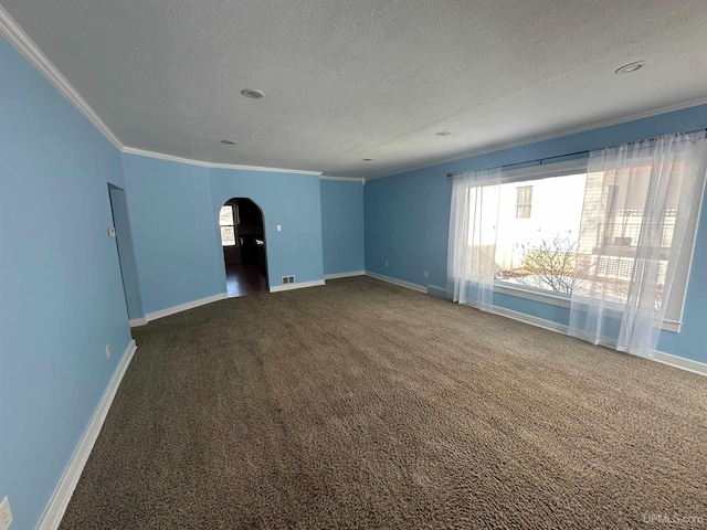 carpeted empty room with arched walkways, ornamental molding, and a healthy amount of sunlight