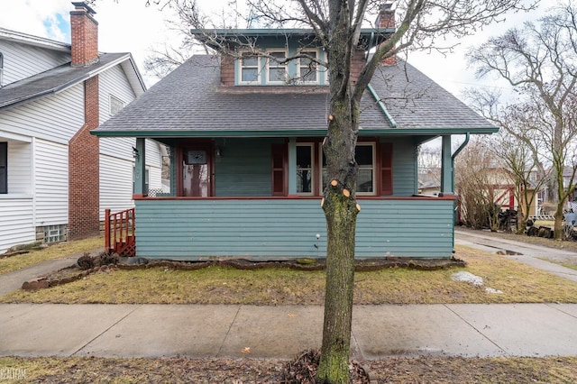 bungalow-style house featuring a shingled roof and covered porch