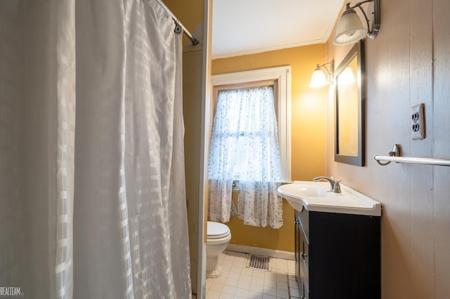 bathroom with visible vents, toilet, tile patterned floors, crown molding, and vanity