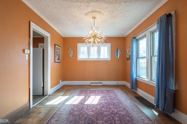 unfurnished dining area with ornamental molding, wood finished floors, visible vents, and a notable chandelier