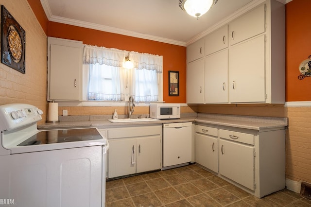 kitchen featuring white appliances, crown molding, light countertops, and a sink