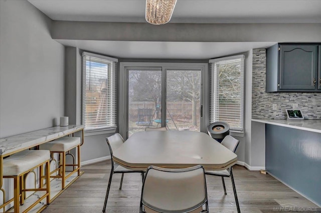 dining area featuring wood finished floors and baseboards