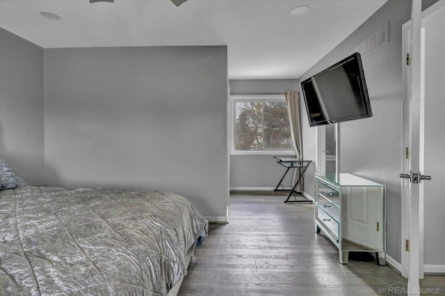 bedroom featuring baseboards and wood finished floors