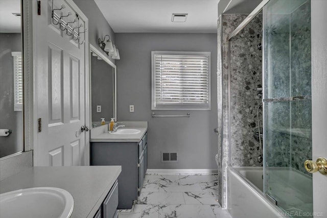 bathroom featuring marble finish floor, bath / shower combo with glass door, visible vents, vanity, and baseboards