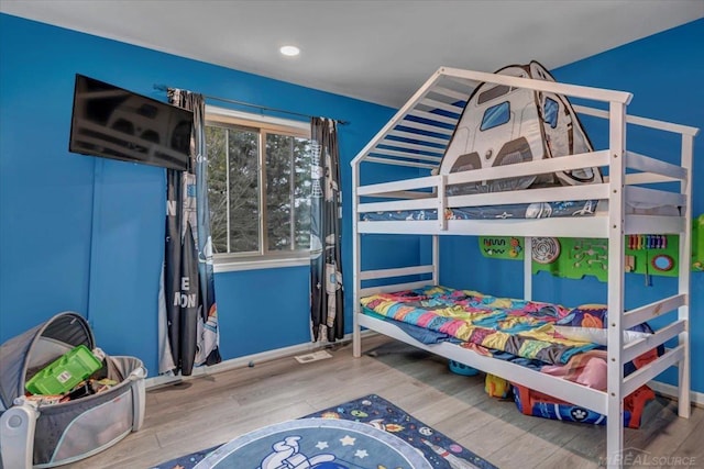 bedroom with wood finished floors