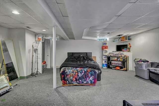 bedroom with a drop ceiling, carpet flooring, and visible vents