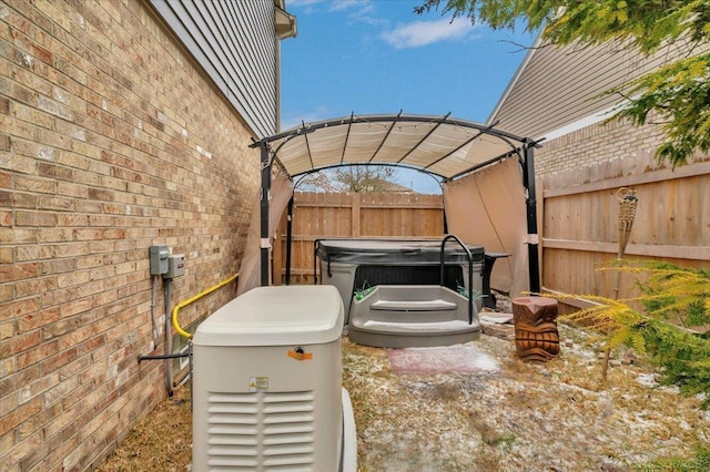 view of patio with fence, a hot tub, and a pergola