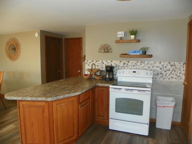 kitchen with dark wood finished floors, white electric range, brown cabinetry, stone countertops, and a peninsula