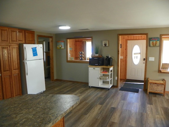 entrance foyer with dark wood finished floors and baseboards