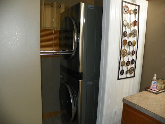 laundry area featuring stacked washer and dryer and laundry area