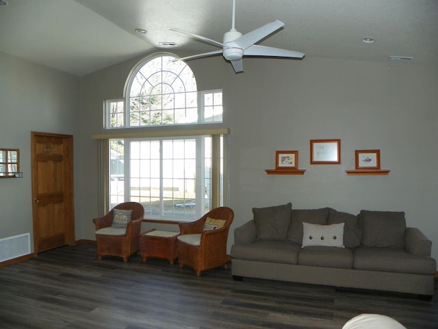 living room with ceiling fan, visible vents, and wood finished floors