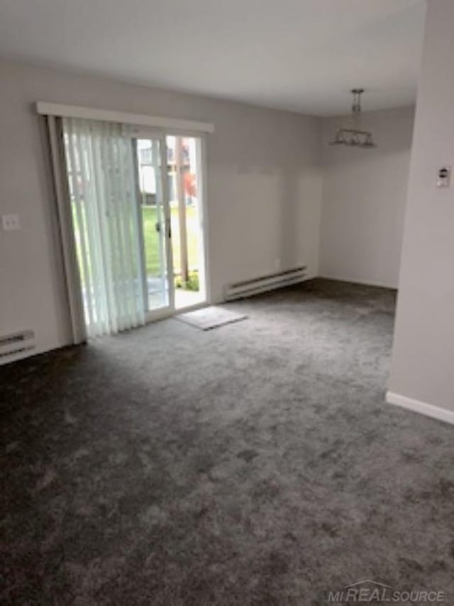 empty room with a baseboard radiator and carpet flooring