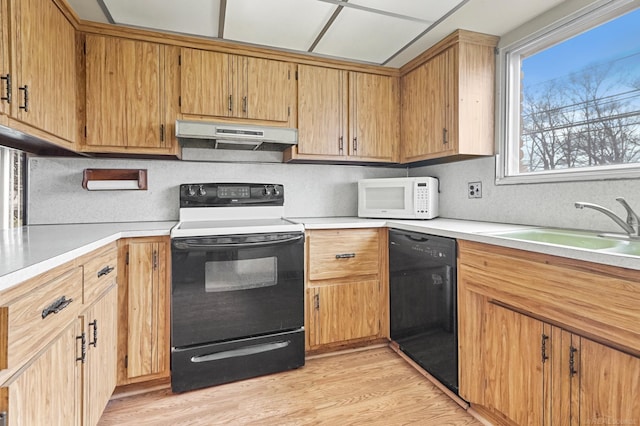 kitchen with black dishwasher, electric stove, white microwave, a sink, and under cabinet range hood