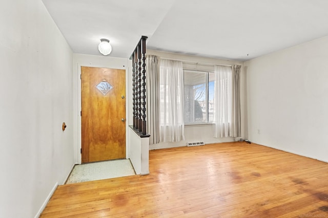 entryway with wood-type flooring and visible vents