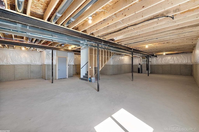 unfinished basement featuring water heater