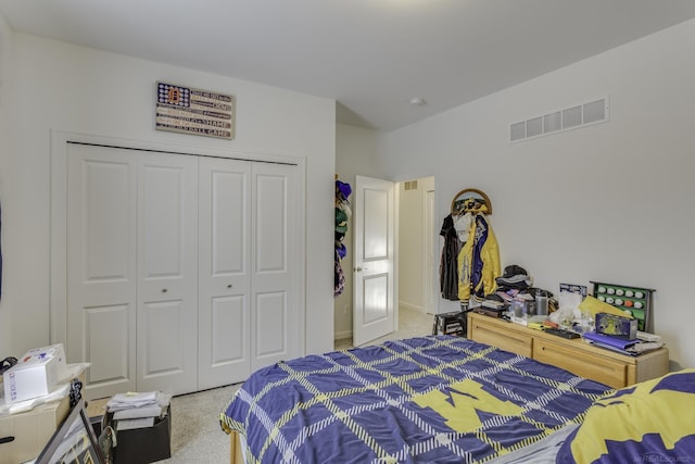 carpeted bedroom featuring a closet and visible vents