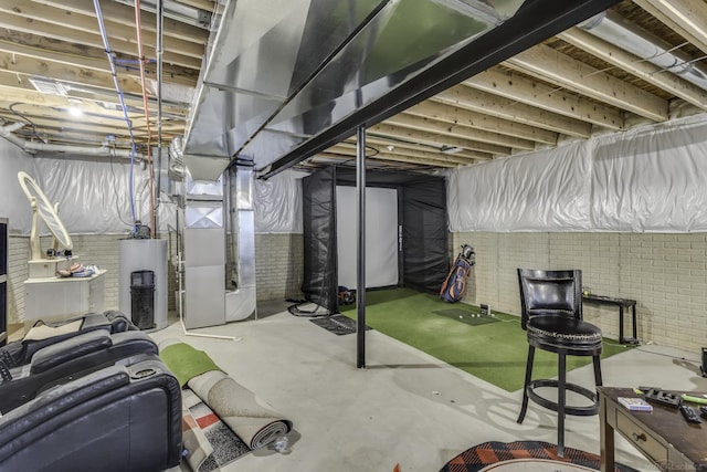 basement with heating unit, brick wall, and gas water heater