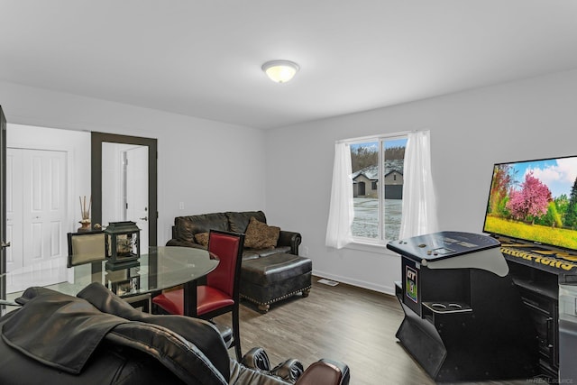 living area featuring wood finished floors and baseboards