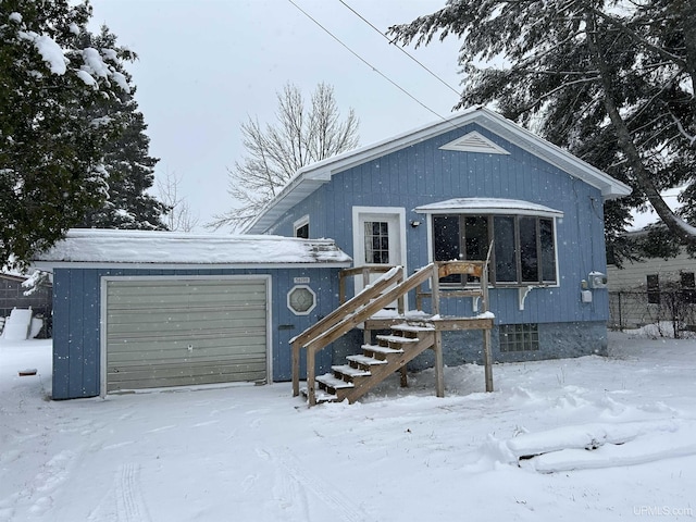 view of front of property with a garage and stairs