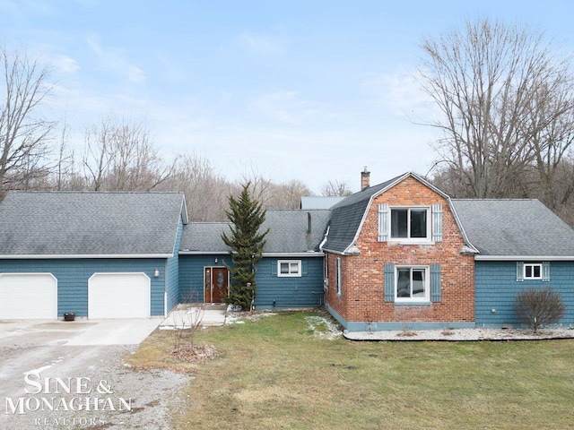 colonial inspired home featuring an attached garage, a gambrel roof, driveway, a chimney, and a front yard