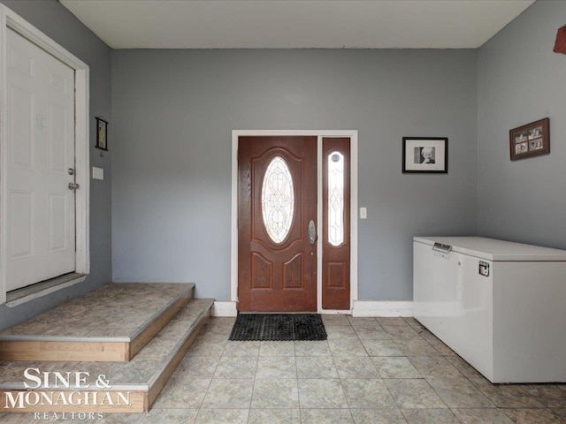 foyer entrance with baseboards