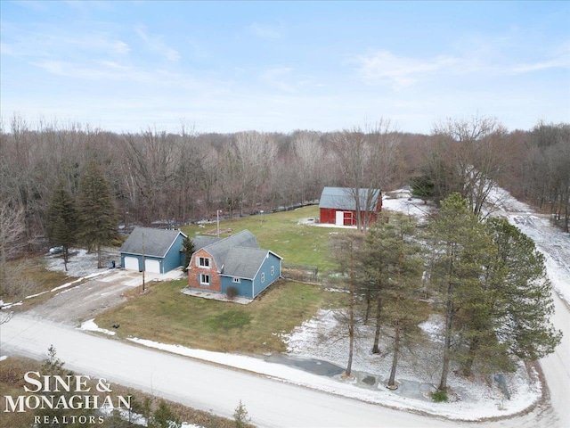 drone / aerial view with a wooded view