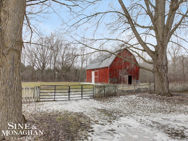 view of barn featuring a gate and fence