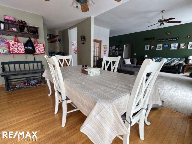 dining space featuring ceiling fan and wood finished floors