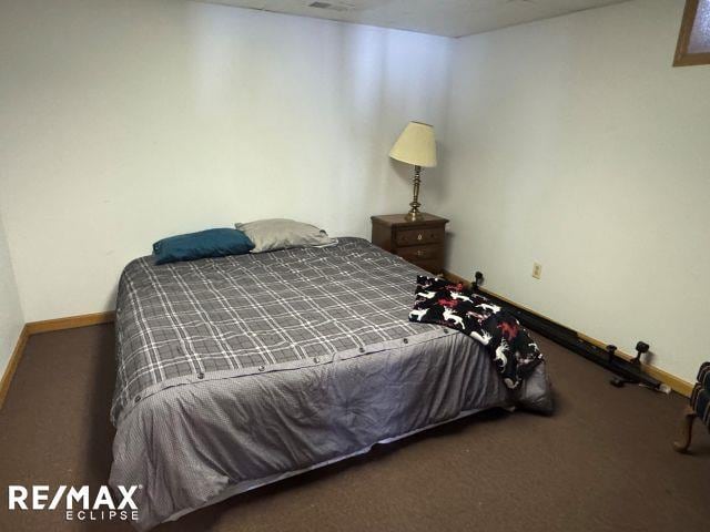 carpeted bedroom featuring baseboards