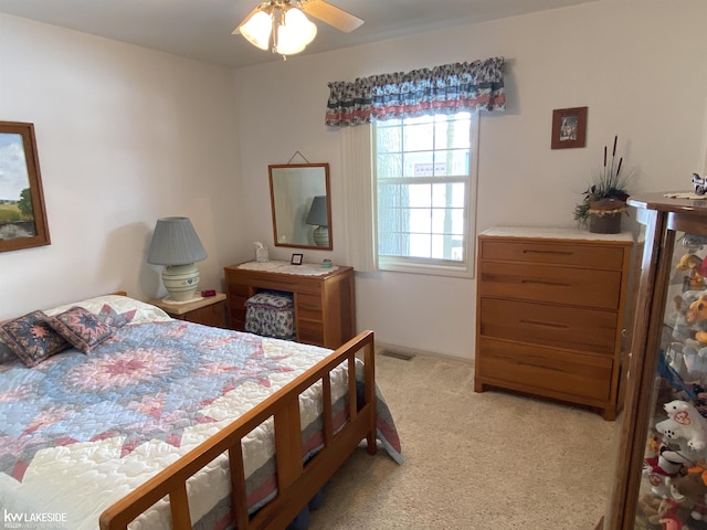 bedroom featuring visible vents and light colored carpet