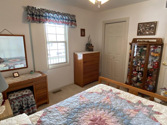 bedroom with light carpet and visible vents