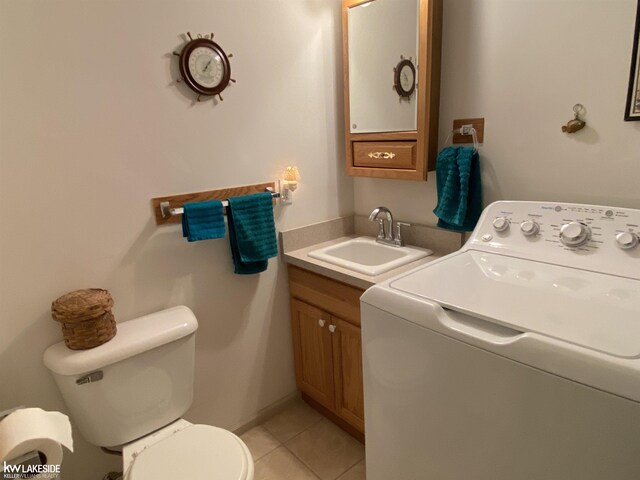 laundry room featuring laundry area, light tile patterned flooring, a sink, and washer / dryer