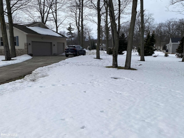 yard covered in snow with a garage