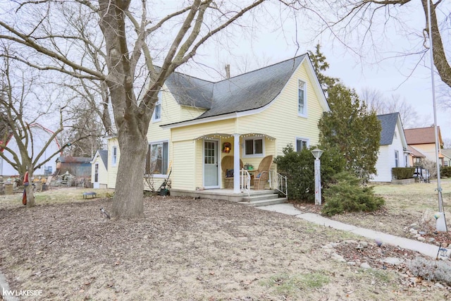 view of front of house featuring covered porch and roof with shingles