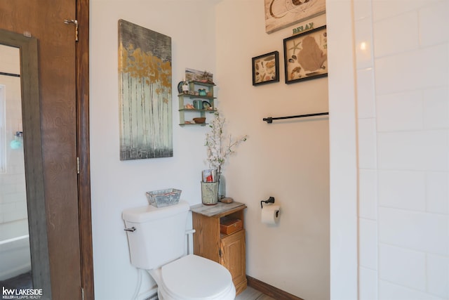 bathroom featuring toilet and walk in shower